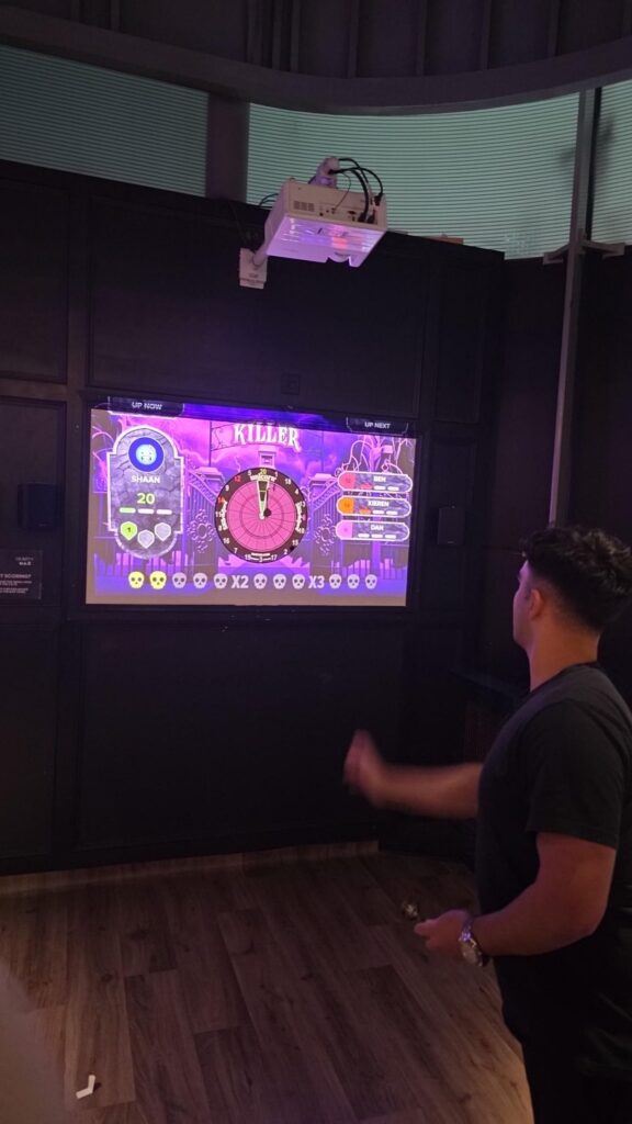 A Langtons colleague taking part in a darts event